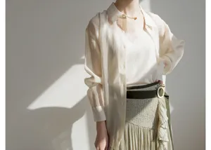 Japanese style sheer blouse and pleated midi skirt detail view showcasing elegant layered design.