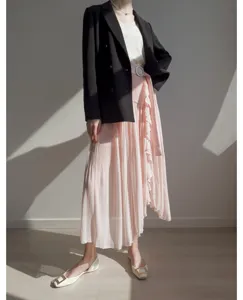 Pink pleated high-waisted split culottes skirt with ruffle detail, elegant daily fashion.