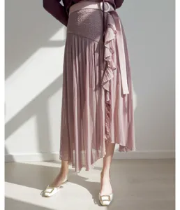 Detailed view of women high waist pleated midi skirt culotte with ruffles and waist tie.