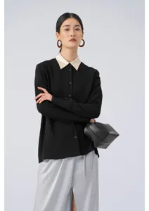 Detailed view of women's black long-sleeve blouse with contrast beige collar and smooth fabric.
