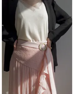 Pink pleated midi skirt with high waist and stylish blazer outfit for women spring fashion.