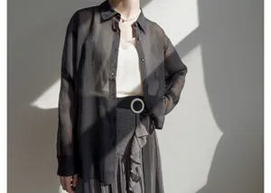 Japanese style pleated skirt and sheer shirt outfit, elegant detail view for spring.