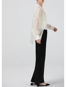 Sheer organza blouse detail showing lightweight texture and elegant drape on model.