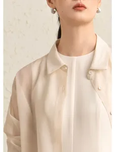 Elegant sheer organza shirt detail view showcasing crisp collar and delicate buttons.