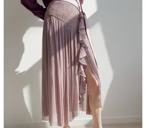 Detail view of a stylish high-waist pleated midi skirt with front slit, ruffles, and chic drape.