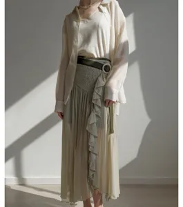 Detail view of Japanese pleated high-waist split skirt pants with delicate ruffle trim.