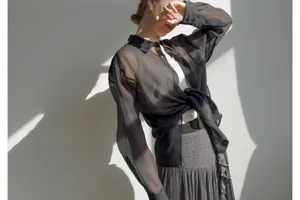 Japanese style sheer black long sleeve shirt paired with high waist pleated skirt detail shot.
