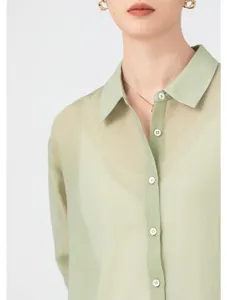 Close-up detail of light green sheer organza button-down shirt collar and front placket.