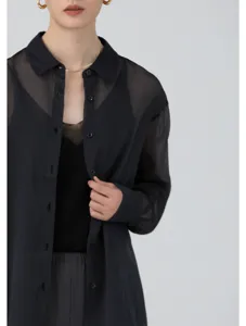 Close-up detail view of the sheer black organza button-down shirt fabric and collar.