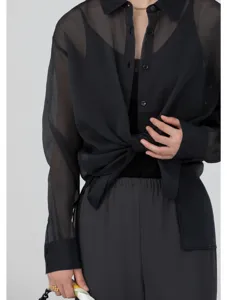 Sheer black organza button-up shirt detail, lightweight summer sun protection top.