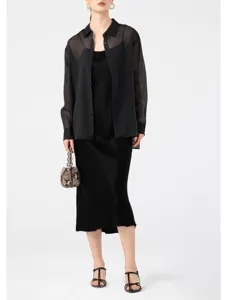 Detail view of women black sheer organza shirt with lightweight sheer fabric and loose fit.