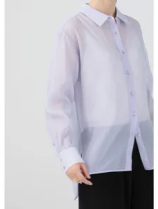 Sheer organza blouse detail showing lightweight fabric texture, long sleeves and button cuff.