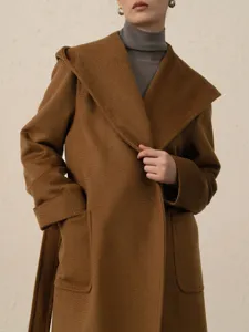 Camel hooded wool coat for women, elegant long cashmere winter outerwear with belt pockets.