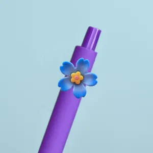 Nahaufnahme Detail des lila Gelstifts mit blauem Kunstharz Blumen Anhänger Schreibwaren