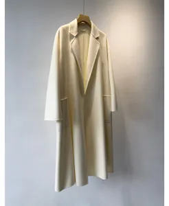 Detail view of a women's long cream wool blend wrap coat showing classic lapel design.