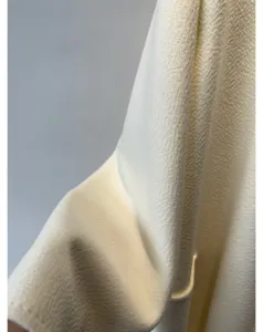 Luxury cashmere wool coat fabric detail, premium water ripple texture, soft winter material