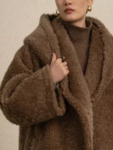 Brown hooded teddy wool coat for women, cozy winter long fuzzy outerwear for stylish look.