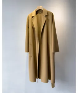 Detail view of luxury camel cashmere blend long bathrobe coat featuring elegant lapel and belt.