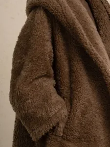 Close up of brown fleece hooded teddy coat, stylish warm winter fluffy outerwear for women.
