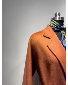 Orange cashmere blend bathrobe coat detail, elegant lapel design for women winter wear.