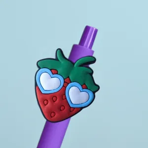 Detailed close-up view of the cute purple gel pen showing the 3D strawberry charm.