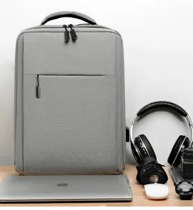 Grey business laptop backpack detail, multi-functional commuting bag setup on office desktop.
