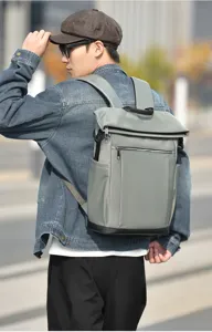 Detail view of stylish grey roll-top backpack for men, ideal for business commute and travel.