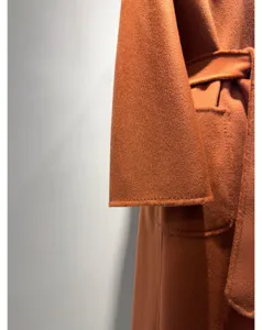 Premium camel cashmere wrap coat detail view, elegant long winter coat with belt.
