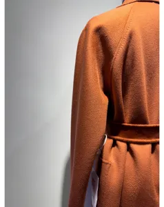 Detailed view of the elegant caramel cashmere blend long robe coat with matching waist belt.