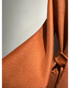 Luxurious cashmere coat fabric detail, soft texture and elegant drape for winter style.