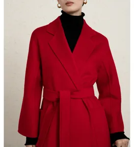 Close-up detail of the red cashmere wrap coat with belt and elegant texture for women.