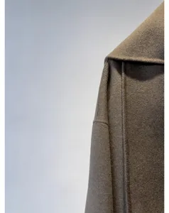 Gros plan détail de la veste manteau cachemire laine double face épaule et écharpe.