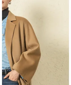 Close-up detail of a classic camel double-faced cashmere wrap coat, elegant style for autumn.