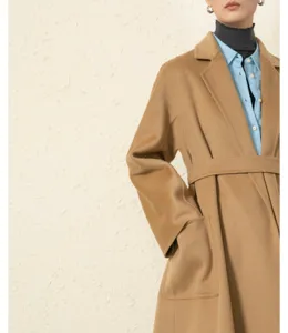 Luxury cashmere camel wrap coat detail, elegant long winter outerwear with belt and pockets.