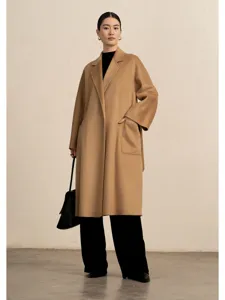 Detailed view of the luxurious camel cashmere wrap coat featuring a classic lapel and side pockets.