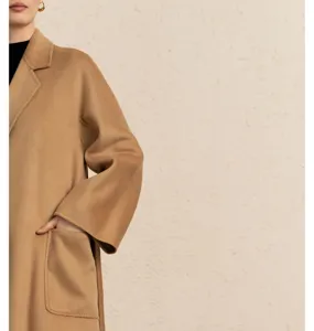 Detailed view of women's luxury camel cashmere wrap coat, elegant double-faced wool fabric.