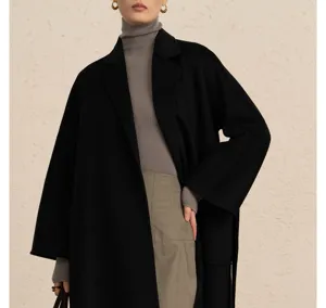 Luxury black wool blend long coat detail view, featuring classic lapel and matching belt.