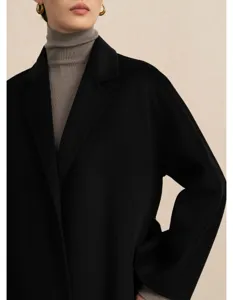 Women's classic black double-faced wool long coat detail, elegant winter outerwear style.