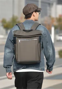Detail shot of a stylish men's business casual backpack with roll-top design and large capacity.