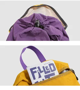 Outdoor hiking sports backpack detail showing purple drawstring inner lining and front zip pocket.