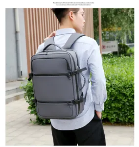 Grande zaino da viaggio business grigio con scomparti multipli e cinghie laterali per uomini.