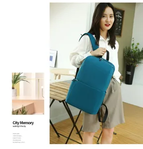 Casual minimalist backpack for daily use, stylish cyan school bag with spacious compartments.
