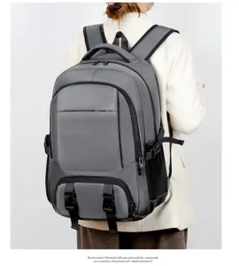 Detail shot of grey travel backpack worn on model, showing large capacity and multi-compartment design.