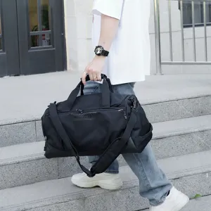 Black large capacity fitness gym travel bag held by model outdoors main view daily use