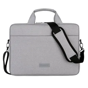 Grijze laptoptas voor zakenreizen met schouderriem en stevig handvat voor dagelijks gebruik.