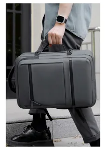 Close-up detail of the gray business laptop backpack with smooth black zippers and handle.