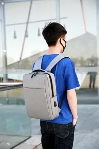 Large capacity 17 inch grey casual travel backpack for men and women with USB charging port.