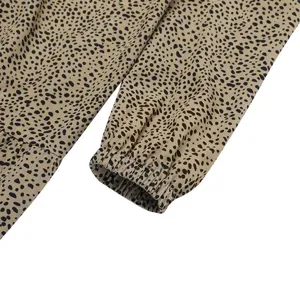 Close-up detail of the printed long sleeve cuff showing fabric texture and pattern.