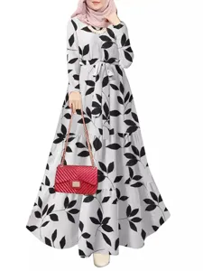 Elegant long-sleeve maxi dress featuring a chic black leaf print, belt, and flowy hem.