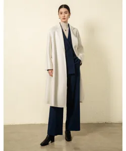 Elegant women's white cashmere coat detail shot featuring premium texture and design.